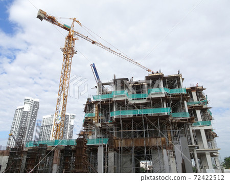 MALACCA, MALAYSIA -MARCH 2, 2020: Construction workers working at height at the construction site. They are supplied with harnesses and other safety equipment to prevent them from having an accident. 72422512