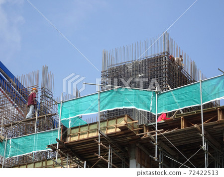 MALACCA, MALAYSIA -MARCH 2, 2020: Construction workers working at height at the construction site. They are supplied with harnesses and other safety equipment to prevent them from having an accident. 72422513