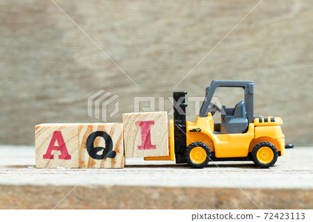 Toy forklift hold letter block I to complete word AQI (Air quality index)on wood background Toy forklift hold letter block I to complete word AQI (Air quality index)on wood background 72423113