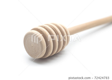 Closeup of wooden honey spoon on white background 72424783