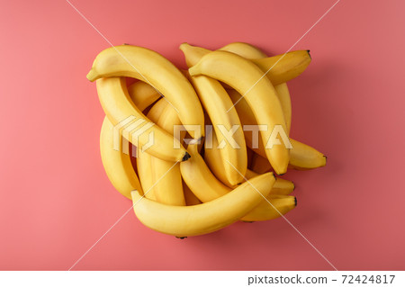 Fresh bunch of yellow bananas isolated on a pink background. Fresh bunch of yellow bananas isolated on a pink background. 72424817