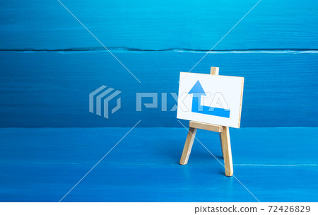 Easel with a blue left arrow. Minimalism. Direction to go around on the left. Advertising. Navigation, customer acquisition. Obscure obstacles, move towards the goal. New rules. Copy space 72426829