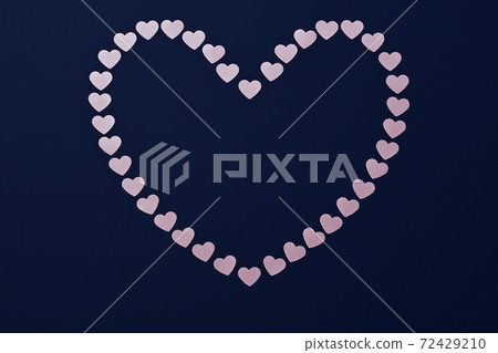 Heart of pink Valentines on a dark blue background with space for text. 72429210