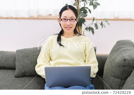 Woman using a laptop Woman using a laptop 72429229