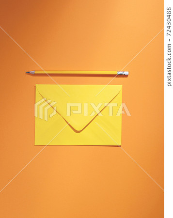 Marigold orange coloured envelope and pencil. Marigold orange coloured envelope and pencil. 72430488