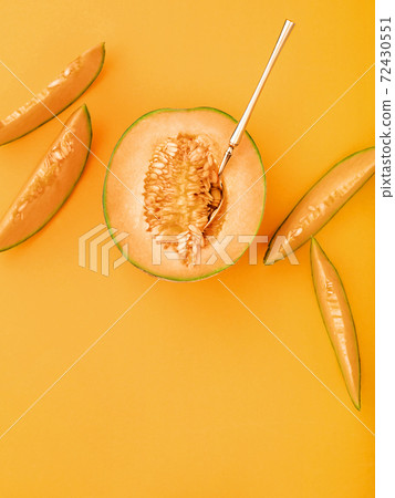 Melon and slices on marigold coloured background. Melon and slices on marigold coloured background. 72430551