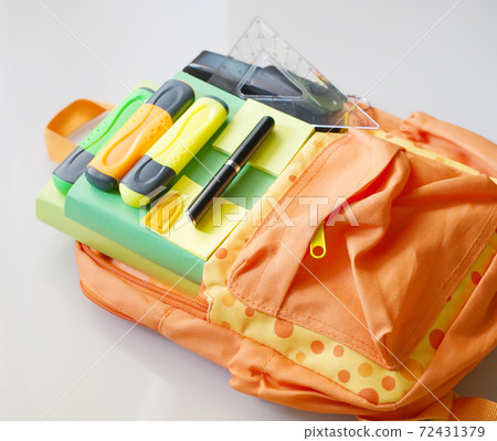 Backpack with school supplies spilling out. Back to School concept.  72431379
