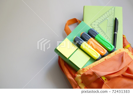Backpack with school supplies spilling out. Back to School concept.  Backpack with school supplies spilling out. Back to School concept.  72431383