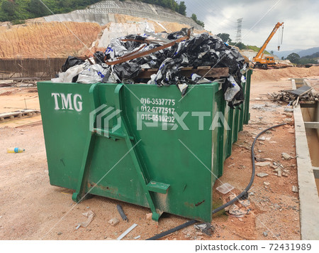 KUALA LUMPUR, MALAYSIA -MARCH 13, 2020: Huge wasted disposal bin used to collect rubbish and unused material from the construction site. Has a fixed collection schedule KUALA LUMPUR, MALAYSIA -MARCH 13, 2020: Huge wasted disposal bin used to collect rubbish and unused material from the construction site. Has a fixed collection schedule 72431989