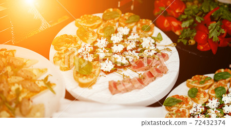 delicious jerky on a white plate with catering sandwiches 72432374
