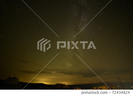 Milky Way in the orange city-lit night sky 72434824