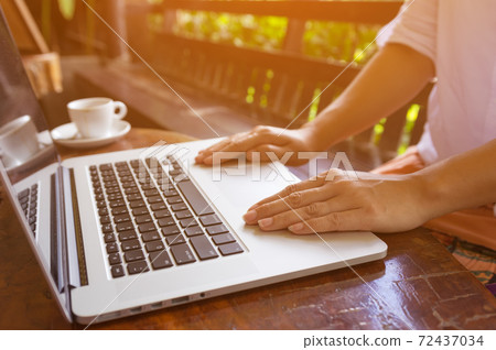 Hand on laptop. 72437034