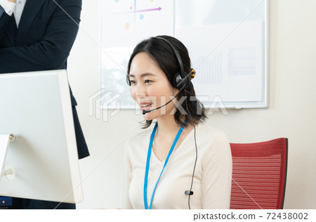 A woman working at a call center A woman working at a call center 72438002