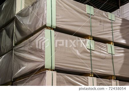 numbered and packed in plastic film pallets with drywall are stacked on top of each other in the building materials warehouse numbered and packed in plastic film pallets with drywall are stacked on top of each other in the building materials warehouse 72438054