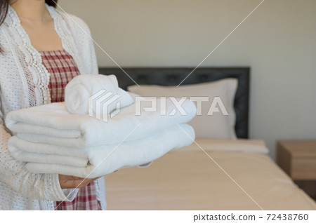 Soft towels on bedroom. 72438760