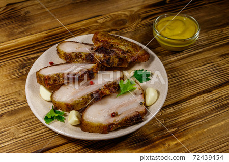 Baked pork belly in a plate on wooden table Baked pork belly in a plate on wooden table 72439454