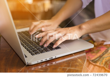 Hand on laptop. 72439670