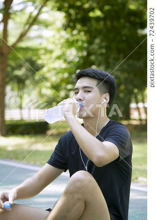 Man taking a break from exercise Man taking a break from exercise 72439702