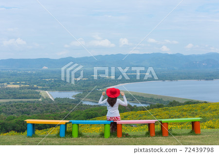 Beautiful woman in nature flower. 72439798