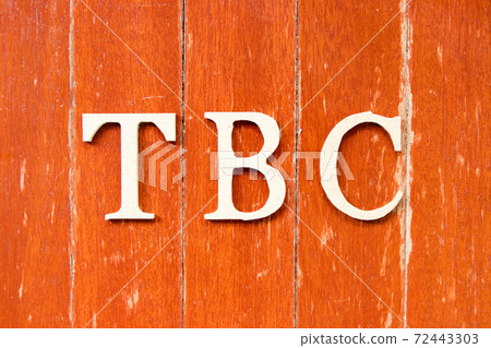 Alphabet letter in word  TBC (Abbreviation of to be confirmed or continued) on old red color wood plate background 72443303