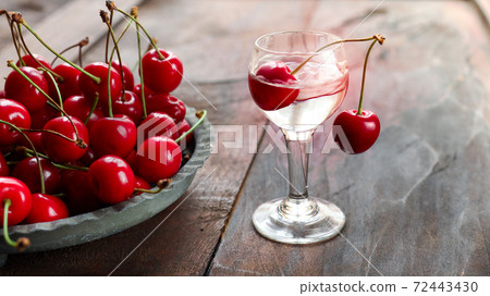 Kirsch or Kirschwasser in a glass and fresh cherry 72443430