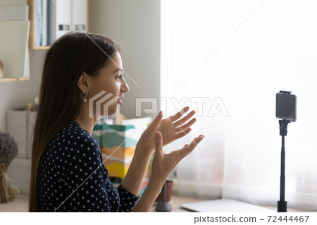 Close up woman recording video, using smartphone on tripod Close up woman recording video, using smartphone on tripod 72444467