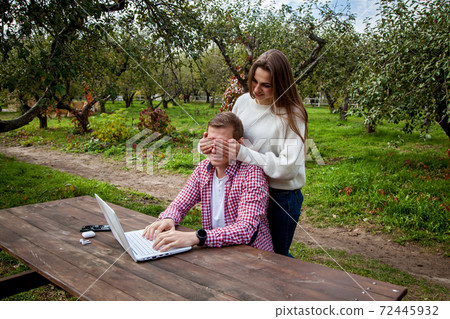 guy with girl with gadgets in the park 72445932