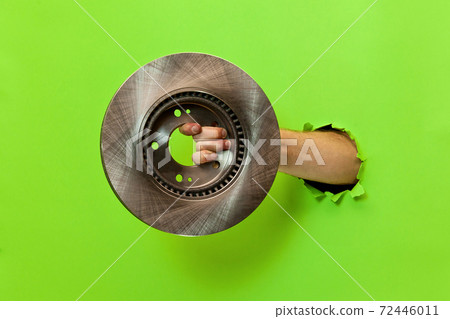 hand through torn green paper hand through torn green paper 72446011