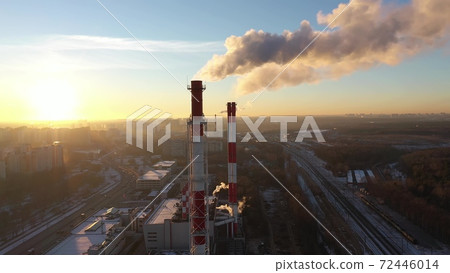 Aerial shot of red and white industrial smoke stacks on sunset background. Moscow, Russia 72446014