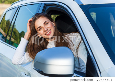 the girl in the car looking out the window 72446505