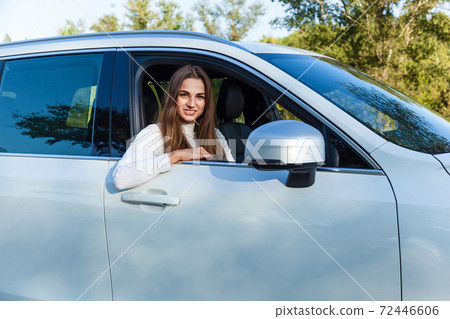 the girl in the car looking out the window 72446606