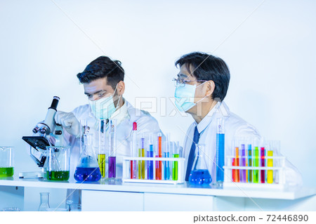 Team of research scientists analysing test trial new generation vaccine data. Team of research scientists analysing test trial new generation vaccine data. 72446890