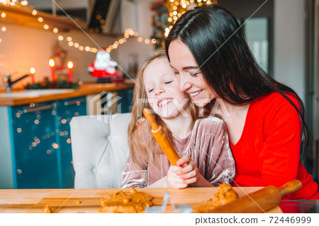 Happy family mother and daughter bake cookies for Christmas 72446999