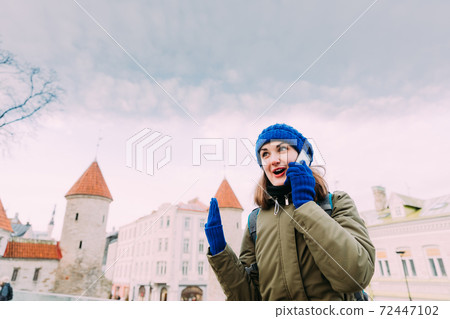 Tallinn, Estonia. Young Caucasian Woman Backpacker Tourist Enjoying Life, Smiling And Calling On Smartphone Near Landmark Viru Gate. Vacation In Old Town. Girl Surfing Net Internet In Phone Tallinn, Estonia. Young Caucasian Woman Backpacker Tourist Enjoying Life, Smiling And Calling On Smartphone Near Landmark Viru Gate. Vacation In Old Town. Girl Surfing Net Internet In Phone 72447102