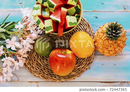 coloured above view of mixed tasty fruits on a blue wooden table - apple, watermelon, pine and more - vitamin and diet healthy fruit for perfect lifestyle coloured above view of mixed tasty fruits on a blue wooden table - apple, watermelon, pine and more - vitamin and diet healthy fruit for perfect lifestyle 72447365