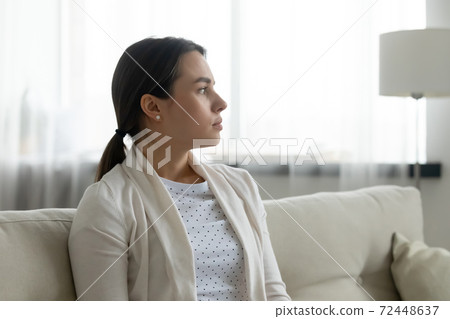 Close up thoughtful upset young woman thinking about problems Close up thoughtful upset young woman thinking about problems 72448637