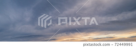 Fluffy clouds in evening overcast sky panoramic view. Climate, environment and weather concept sky background. 72449991