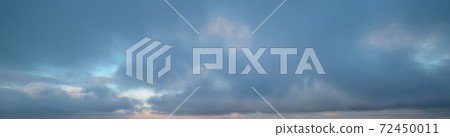 Fluffy clouds in evening overcast sky panoramic view. Climate, environment and weather concept sky background. 72450011