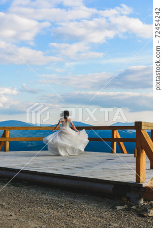 A couple of brides in the picturesque Carpathians, a mountain range of the Ukrainian Carpathians. A couple of brides in the picturesque Carpathians, a mountain range of the Ukrainian Carpathians. 72454242