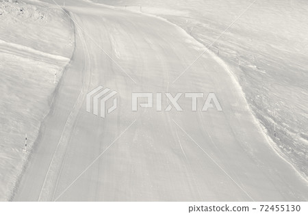 Prepared snowy ski slope after snow grooming machine Prepared snowy ski slope after snow grooming machine 72455130