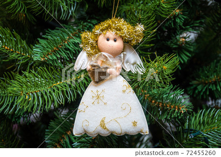 Russia. Saint-Petersburg. Christmas tree decoration white angel with shiny wings and Golden hair. 72455260