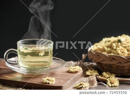 Chrysanthemum tea with hot steam on black background. Chrysanthemum tea with hot steam on black background. 72455550