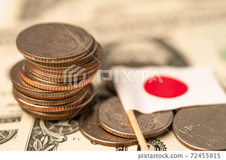 Stack of coins with Japan flag on USA America dollar banknotes. Stack of coins with Japan flag on USA America dollar banknotes. 72455915