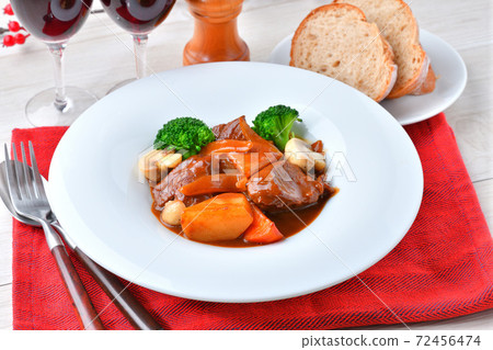 Beef stew (beef sneak, red wine + demiglace sauce) with mushrooms, carrots and broccoli. Beef stew (beef sneak, red wine + demiglace sauce) with mushrooms, carrots and broccoli. 72456474