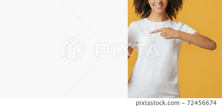 Smiling modern blogger or student offering ad Smiling modern blogger or student offering ad 72456674