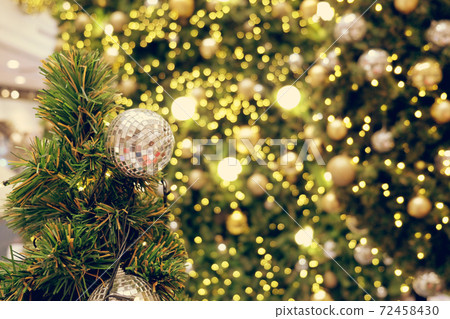 Christmas background of de-focused lights with decorated tree Christmas background of de-focused lights with decorated tree 72458430