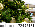 Christmas background of de-focused lights with decorated tree 72458431