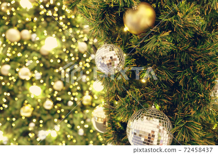 Christmas background of de-focused lights with decorated tree Christmas background of de-focused lights with decorated tree 72458437