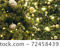 Christmas background of de-focused lights with decorated tree 72458439