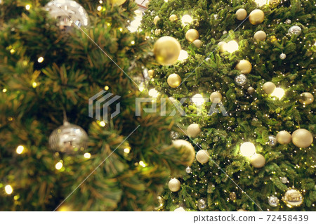 Christmas background of de-focused lights with decorated tree Christmas background of de-focused lights with decorated tree 72458439